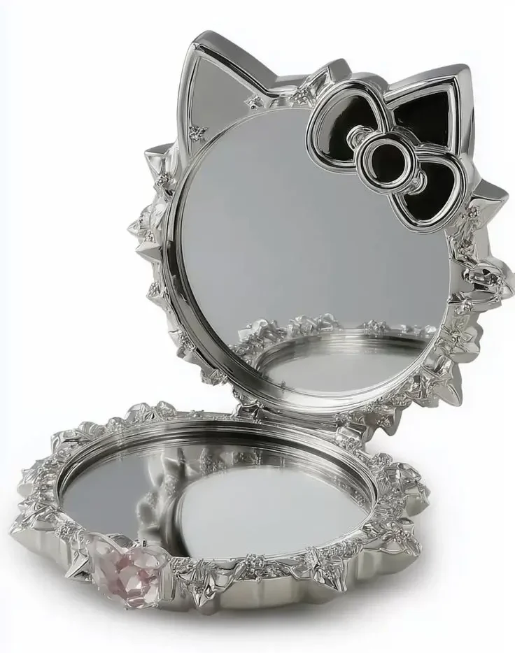 Original silver cat-shaped compact mirror with a black bow on a white background